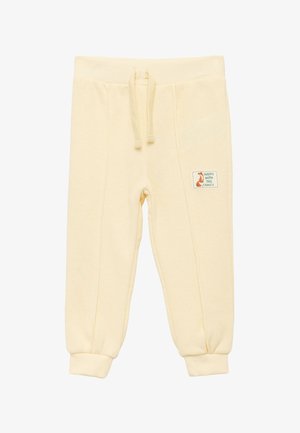 Lichtgele katoenen sweatpants met elastische tailleband en trekkoord, voorzien van zijzakken en een klein vierkant patch met tekst.