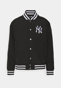 Black varsity jacket with white striped ribbed collar and cuffs, featuring front snap buttons and embroidered NY logo on the chest.