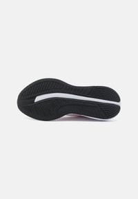 Black rubber sole with textured patterns and a white stripe. The shoe design appears athletic with ergonomic contours.