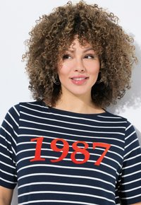 Camiseta de rayas azul marino con mangas cortas, que presenta un audaz estampado rojo con "1987" en el pecho. Tejido suave con escote redondo.