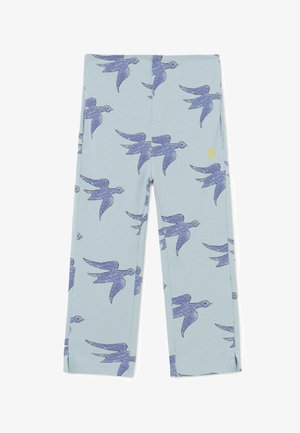 Leggings blu con un motivo di uccelli, realizzati in materiale morbido. Forme geometriche e un dettaglio giallo sono visibili all'altezza della vita.