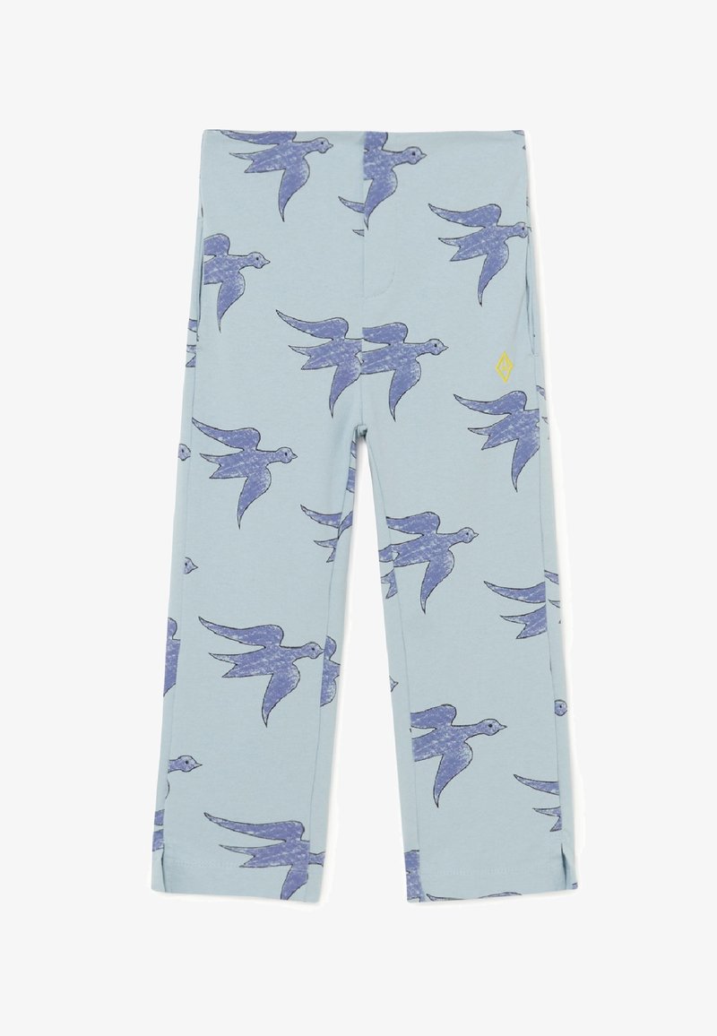 Leggings bleus avec un motif d'oiseaux, fabriqués en matériau doux. Des formes géométriques et un détail d'accent jaune sont visibles à la taille.