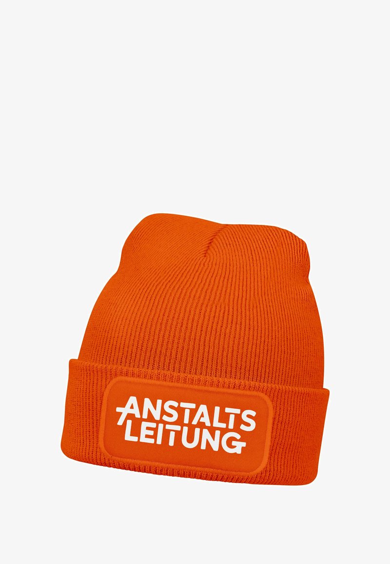 Orange knitted beanie with a folded cuff, featuring a rectangular patch with the text "ANSTALTSLEITUNG" in white. Textured ribbed pattern.