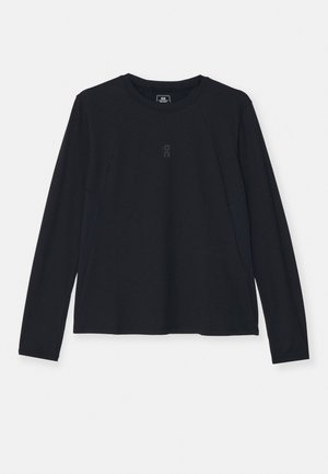 T-shirt de sport à manches longues noir avec des manches raglan, col rond et détail de logo subtil sur la poitrine. Tissu lisse et extensible.