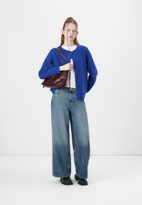 Blue knitted cardigan with buttons, white shirt, wide-leg denim jeans, black boots, and a burgundy handbag. Simple design.