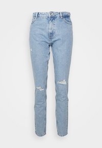 Světle modré džíny z denimu se zvýšeným pasem, úzkým střihem a opotřebovanými detaily se třásněmi na obou nohavicích. Klasický pětikapsový design.