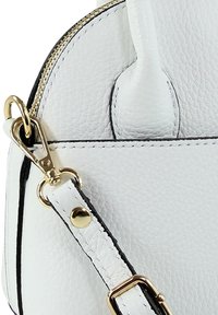 White leather handbag featuring a textured surface, gold-tone hardware, and a curved zipper. Includes a detachable strap with black accents.
