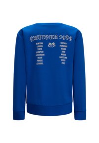 Felpa blu con colletto rotondo e maniche lunghe. Stampa sul retro con "(RE)TOUR 1989" e nomi delle città in bianco. Tessuto morbido.