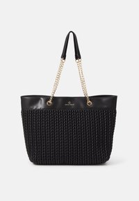 Bolso tote negro con un diseño de tejido texturizado, parte superior de cuero suave y acentos de cadena dorada sujetos a las asas.
