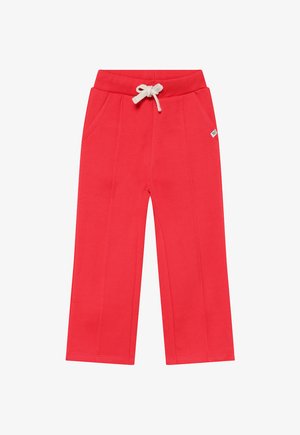 Pantalon de survêtement en coton rouge avec taille à cordon, deux poches latérales et coupe décontractée. Caractéristiques : coutures plates et petite étiquette logo sur le côté.