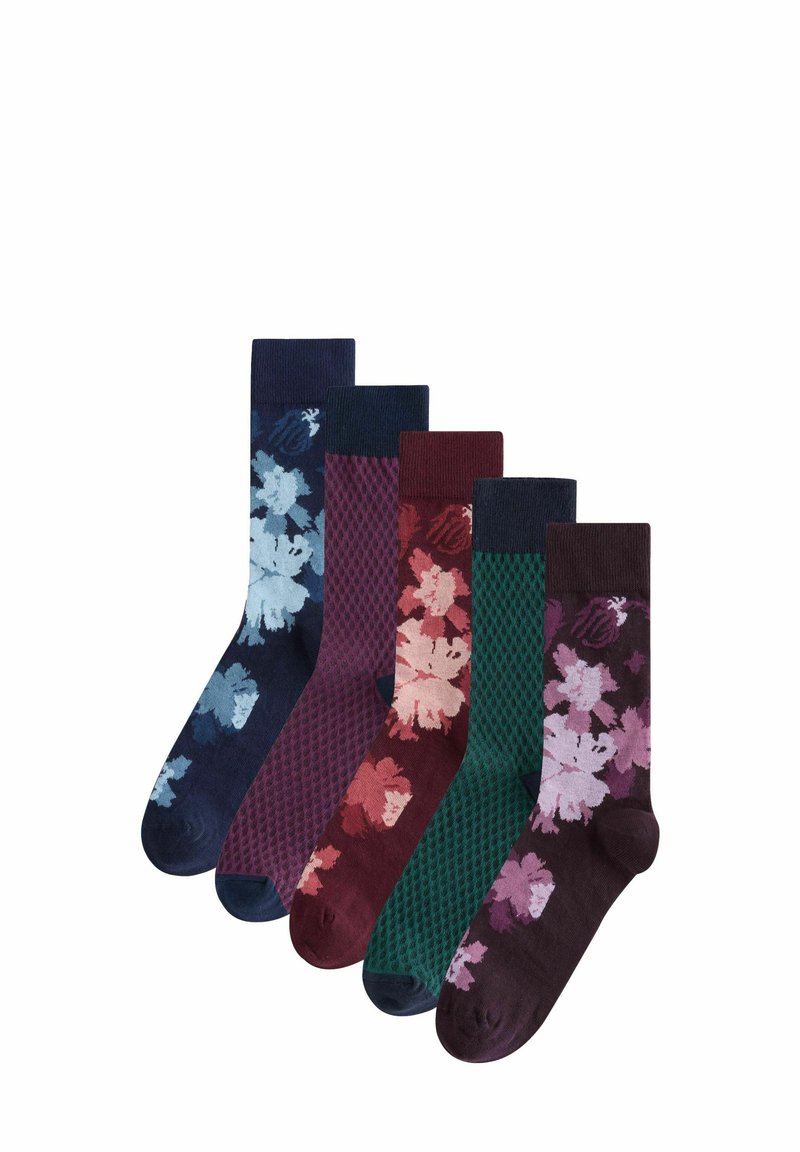 Five pairs of socks in navy, burgundy, and green, featuring floral patterns, textured knits, and solid colors. Different heights and designs.