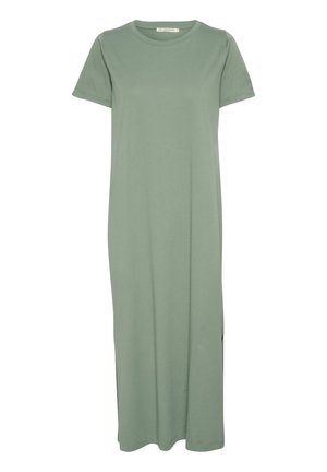 Rochie verde, până la genunchi, din bumbac moale, cu decolteu rotund și mâneci scurte, având fante laterale pentru ușurința mișcării.