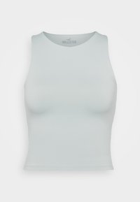 Light blue sleeveless cropped tank top with round neckline, fitted shape, and Hollister logo inside the collar.