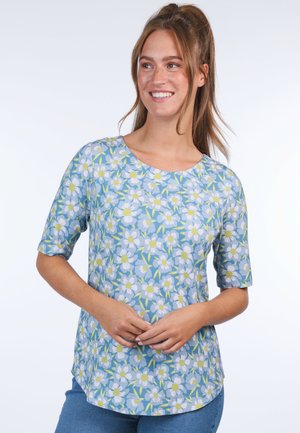 Short-sleeve shirt in light blue fabric with a floral pattern of white daisies and green leaves, round neckline, and a relaxed fit.