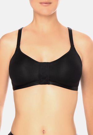 Black sports bra featuring adjustable straps, front-hook closure, seamless design, and smooth texture. Accommodates a comfortable fit.