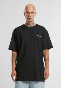 Fekete pamut póló, rövid ujjú, kerek nyakkivágással, bal mellen hímezett "elfeledett szurkolók" logóval kék színben.