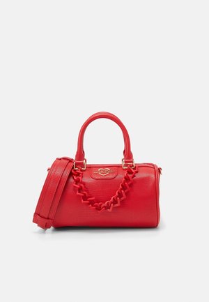 Red textured handbag with double handles, heart-shaped chain detail, detachable shoulder strap, and gold Love Moschino logo plaque.