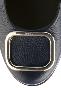 Granatowe skórzane buty o gładkiej fakturze z kwadratowym metalowym akcentem na czubku. Zawiera nazwę marki "högel" wytłoczoną w pobliżu wykończenia.