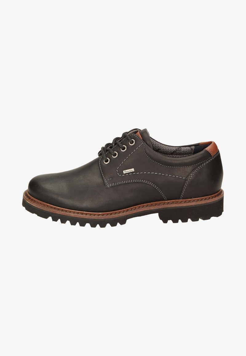 Scarpa in pelle nera con dettagli marroni, punta rotonda, design con sei occhielli per i lacci e suola in gomma robusta. Presenta cuciture a contrasto.