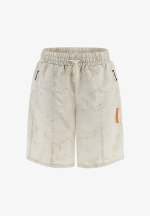 Light beige shorts with a subtle mottled pattern, elastic waistband, drawstring, and black zippered pockets. Features an orange logo patch.