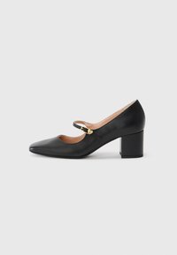 Black leather Mary Jane shoe with a pointed toe, ankle strap featuring a gold buckle, and a stacked block heel. Smooth texture.