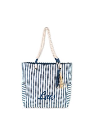 Bolsa tote a rayas en azul y blanco con asa de cuerda, con un tassel y la palabra "La's" en cursiva. Material de algodón texturizado.