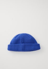 Blue knitted beanie with a ribbed texture and rolled brim. Features a smooth, close-knit pattern, suitable for cold weather.