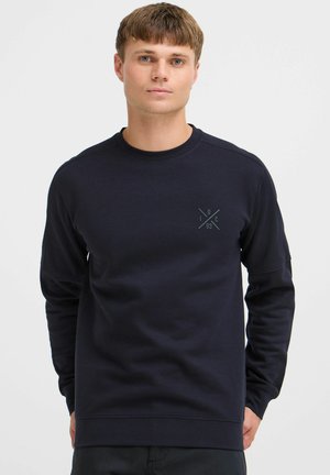 Navy crew-neck sweatshirt in soft fabric, featuring a small graphic logo on the chest, and relaxed fit with long sleeves.
