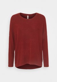 Chemise rouge à manches longues en tissu doux et texturé avec une coupe décontractée, un col arrondi et un ourlet légèrement incurvé.
