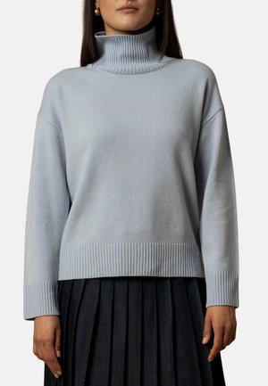 Maglione turtleneck azzurro chiaro realizzato in maglia a coste, caratterizzato da una vestibilità comoda, spalle scese e un orlo a coste orizzontali.