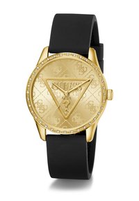 Guldtonad klocka med rund urtavla, svart silikonstrap, präglat logomönster och kristallaccenter runt boetten.