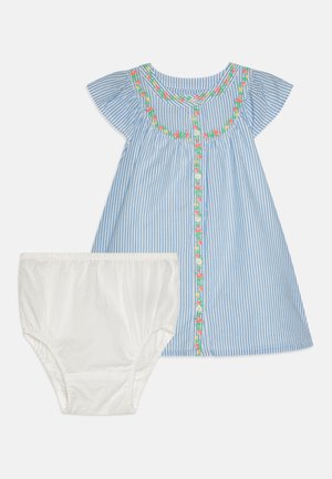 Striped blue dress with floral embroidery along the neckline, accompanied by white shorts. Cotton material, short flutter sleeves, button front.
