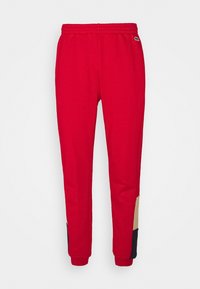 Rote Sweatpants mit elastischem Bund, kontrastierenden beigen und navyblauen Seiteneinsätzen sowie gerippten Bündchen an den Knöcheln. Weicher, strukturierten Stoff.