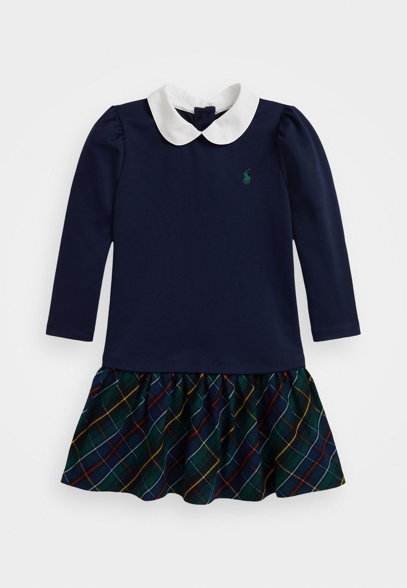 Robe navy avec un col blanc, des manches longues et une jupe à volants en tartan vert, jaune et rouge. Présente un petit logo vert sur la poitrine.