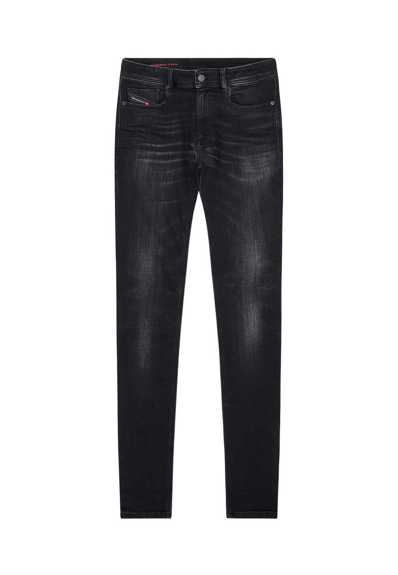 Jean skinny en denim noir avec des décolorations subtiles. Doté d'une fermeture à bouton, de cinq poches et de détails de couture rouge contrastés.
