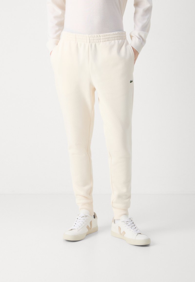 Lacoste Tracksuit bottoms blanc ecru/off-white Zalando