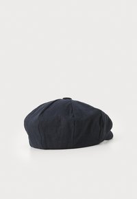 Dark blue linen newsboy cap with a rounded, flat crown and a button accent on top; textured fabric with stitched detailing along seams.