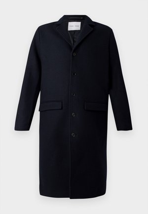 Manteau en laine bleu marine foncé avec col cranté, manches longues, fermeture à boutons, deux poches avant et une coupe droite.