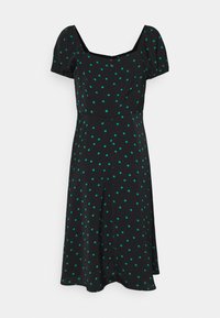 Schwarzes Kleid mit kurzen Puffärmelchen, das türkisfarbene Tupfen, einen quadratischen Ausschnitt und einen fließenden, knielangen Rock mit Seitenschlitzen aufweist.