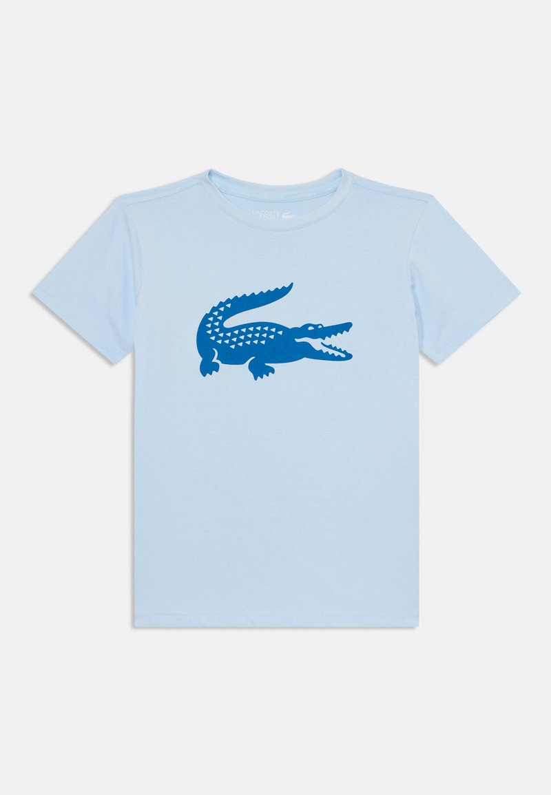 T-shirt di cotone azzurro chiaro con grafica di un coccodrillo blu scuro con motivi a triangolo, scollatura rotonda e maniche corte.