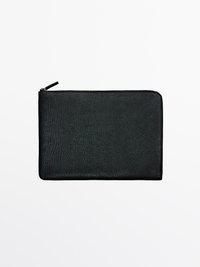 Black leather wallet with a textured surface, zip closure, and rectangular shape. No visible embellishments or hardware.