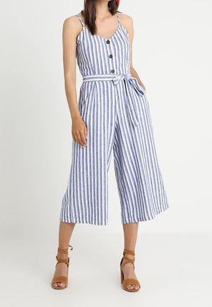 Gestreepte jumpsuit in blauw en wit, met knopen, een ceintuur om te strikken en een wijde pijp. Gemaakt van lichtgewicht stof, geschikt voor warm weer.