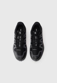 Pair of black and gray Salomon trail running shoes with quick lace system, viewed from above on a white background.