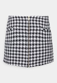 Černobílá mini sukně s houndstooth vzorem z texturované tkaniny, se středovým zipem a dvěma předními kapsami.
