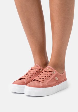 Pink mesh sneakers with a textured upper, white rubber sole, and gold eyelets, featuring a logo on the side and lace-up design.