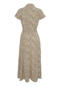 Beige midi-mekko, jossa on lyhyet hihat, vyötärölle sopiva leikkaus ja mustia epäsäännöllisiä pilkkuja, esitetty takaa valkoista taustaa vasten.