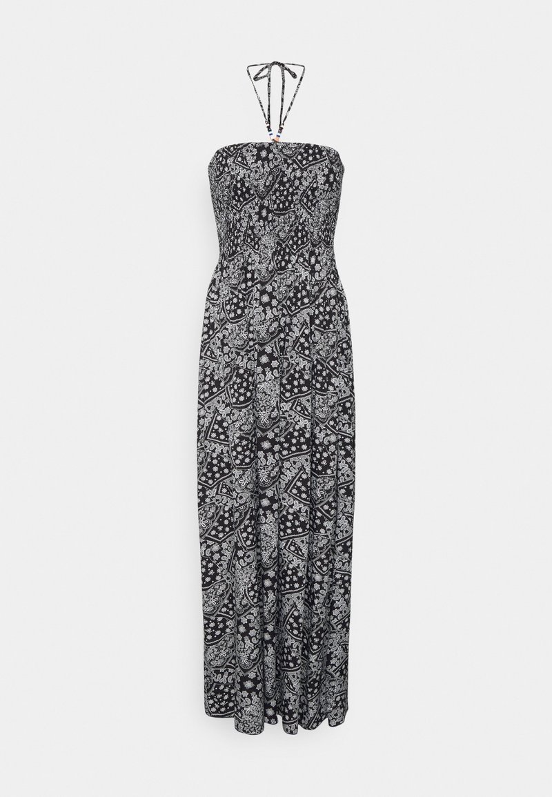 Robe maxi bustier noire et blanche motif paisley avec liens noués autour du cou et jupe fluide sur fond blanc.