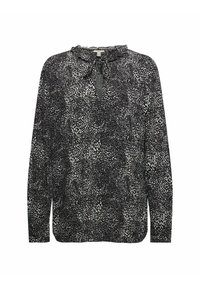 Blouse à manches longues à motifs noir et blanc avec un col à volants et un détail noué en forme de trou de serrure au niveau de l'encolure.