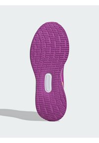 Semelle en caoutchouc violette dotée d'un motif de grip texturé et d'un accent blanc avec une découpe rectangulaire.