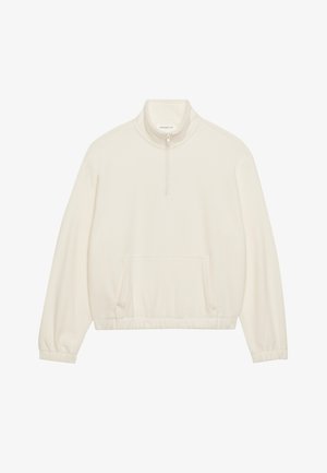 Pull en polaire couleur blanc cassé, avec un col zippé mi-hauteur, une poche avant et un ourlet élastique avec des manches longues et effilées. Texture douce.